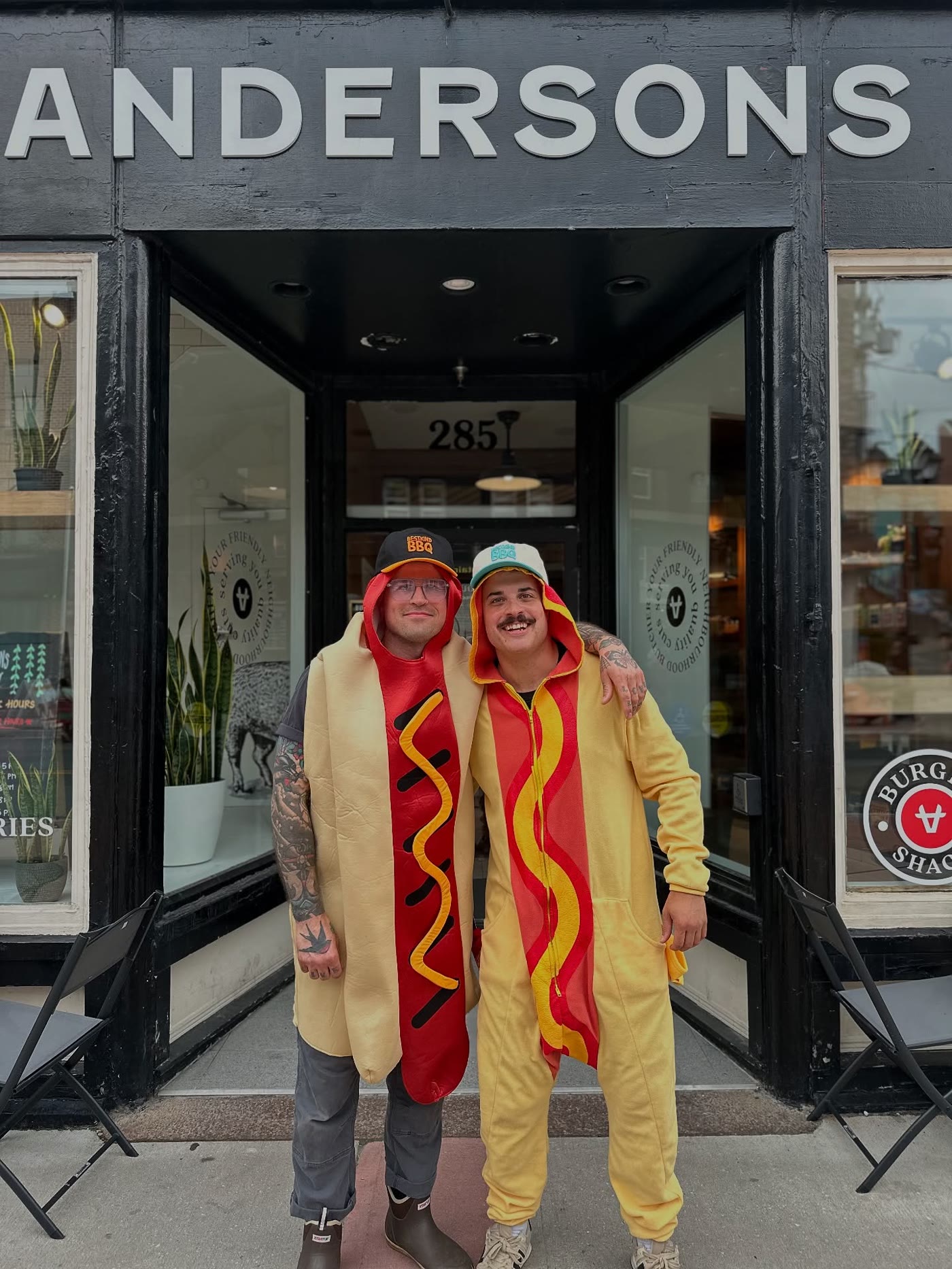 Brent Mac and a friend in hot dog costumes outside Andersons
