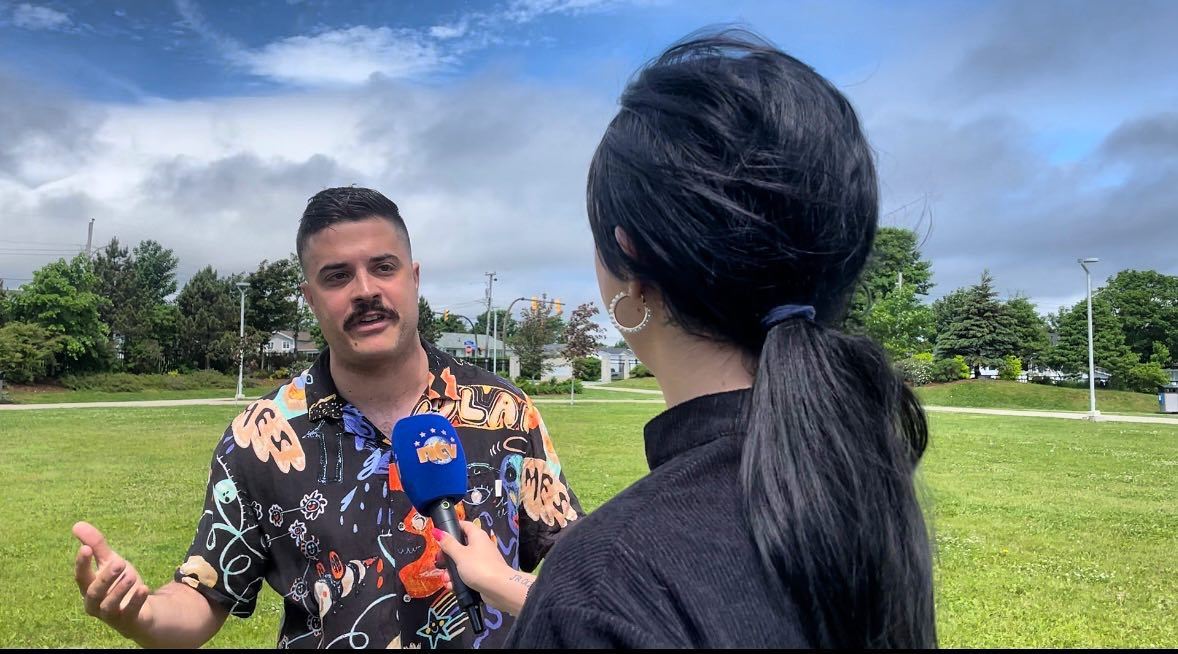 Brent Mac being interviewed by a TV reporter at St. David's Park